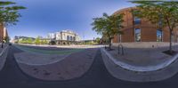 two fisheye images of a city street and the same perspective the photographer was taking