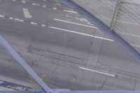 an overhead view of the road from above, with only one car in it and no one on it
