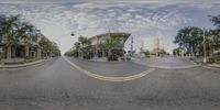 the view of an intersection with the road lined up at the curb and the trees next to it