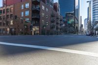 two people waiting at a traffic light in the middle of an empty street in the city