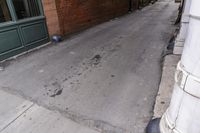 a fire hydrant sitting on a sidewalk next to a building with an open front door