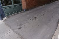 a fire hydrant sitting on a sidewalk next to a building with an open front door