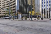 there are many tall buildings on the street corner and an empty roadway in this image