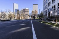 empty street with tall buildings and columns in the background at an angle, near park benches