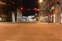 the night sky is clear and there is no image in this picture, there is an empty street with buildings on either side of the road