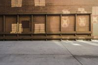the shadow of an animal is projected on the side of the building next to a long bench in front of windows