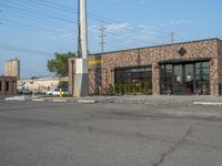 the empty street outside of the business district is empty and deserted with vehicles parked in it