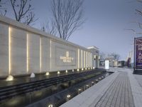 a fountain in a plaza at dusk with fountains around it and the words national museum of korea