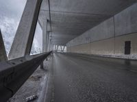 a road is seen under the bridge during a storm in the desert area of colorado