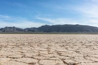 a dry landscape with mountains and sky in the background for advertisement or design purpose, in the middle of this image