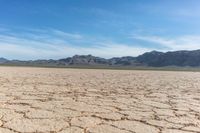 a dry landscape with mountains and sky in the background for advertisement or design purpose, in the middle of this image