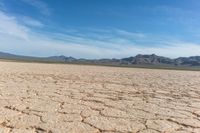 a dry landscape with mountains and sky in the background for advertisement or design purpose, in the middle of this image