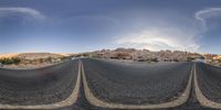 a very wide lens of a road in the middle of the desert on a clear day