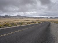 there is a small yellow sign on the side of the road near a large desert area