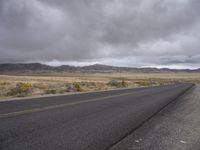 there is a small yellow sign on the side of the road near a large desert area