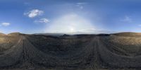 there is a 360 - lens view of some dirt mounds and rocks in the desert