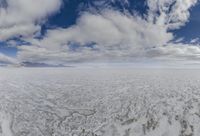 a view from inside a boat in the middle of the ocean with large clouds above