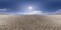 there is a very long desert landscape with a lone person on the horizon in the distance