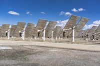 a row of solar panels on the ground of a solar park in the desert setting