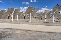 a row of solar panels on the ground of a solar park in the desert setting