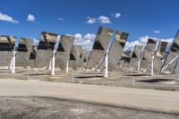 a row of solar panels on the ground of a solar park in the desert setting