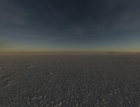 the sun is rising over a plain of barren land and hills on both sides of the horizon