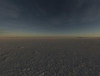 the sun is rising over a plain of barren land and hills on both sides of the horizon