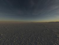 the sun is rising over a plain of barren land and hills on both sides of the horizon