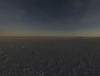 the sun is rising over a plain of barren land and hills on both sides of the horizon