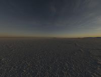 the sun is rising over a plain of barren land and hills on both sides of the horizon