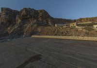 there is a large red sign in the middle of a desert desert area near a rocky area