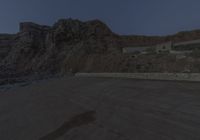 there is a large red sign in the middle of a desert desert area near a rocky area