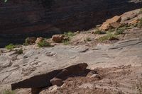 rock formation in an outcropping area by a river in the desert near to a cliff