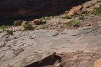 rock formation in an outcropping area by a river in the desert near to a cliff