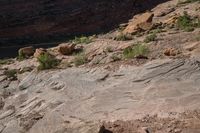 rock formation in an outcropping area by a river in the desert near to a cliff