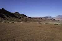 the arid terrain and mountains surround this area for horses to ride in and out of