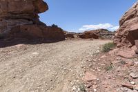 the rocks are big rocks in the desert or an area with no cars on them