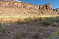 a view of a mountain and grassy area from an overlook looking up at something out in the distance