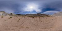 a time lapse photograph of a rocky outcrop in the desert under clouds