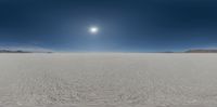 a desert landscape with a sun over the horizon and lots of snow on the ground