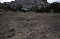 there is a rock on the side of this hill in the desert and there is dirt in the middle