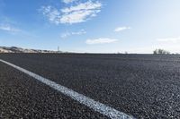 a road that has some lines going up the side and the asphalt in front of it