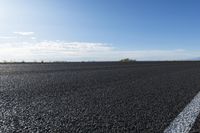 a road that has some lines going up the side and the asphalt in front of it