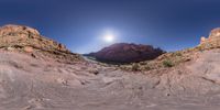 an image of a river in the desert that has a big moon on it and a sun