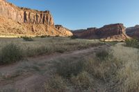 the dirt trail is on the edge of the mountain range in the desert area of the area