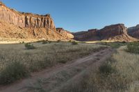 the dirt trail is on the edge of the mountain range in the desert area of the area