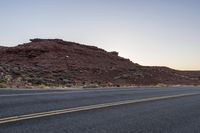 Desert Road at Dawn: A Scenic Mountain Landscape