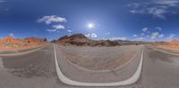 360 - time panoramic photograph of desert road in the mountains and sunraying