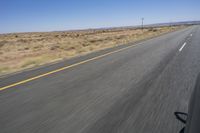 the view from inside a car of an empty highway in motion with cars on both sides of it