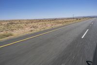 the view from inside a car of an empty highway in motion with cars on both sides of it